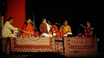 भरतनाट्यम प्रस्तुति में संगतकारों के साथ नट्टुवनार तालम् (नट्टुवांगम झाँझ) बजाते हुए